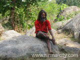 Unknown person sitting at Jungle Hanuman Temple, Bangalpet, Nirmal